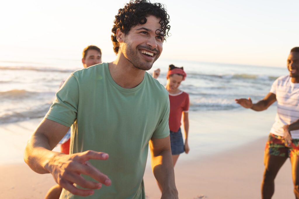 man enjoying the beach with friends