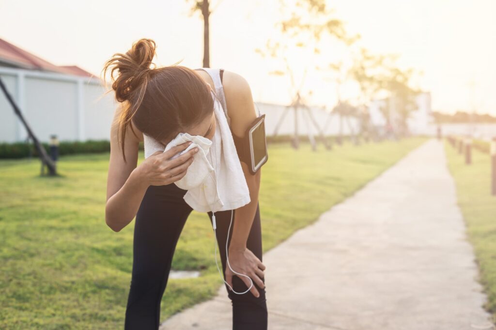 a girl is toweling off because she sweats too much