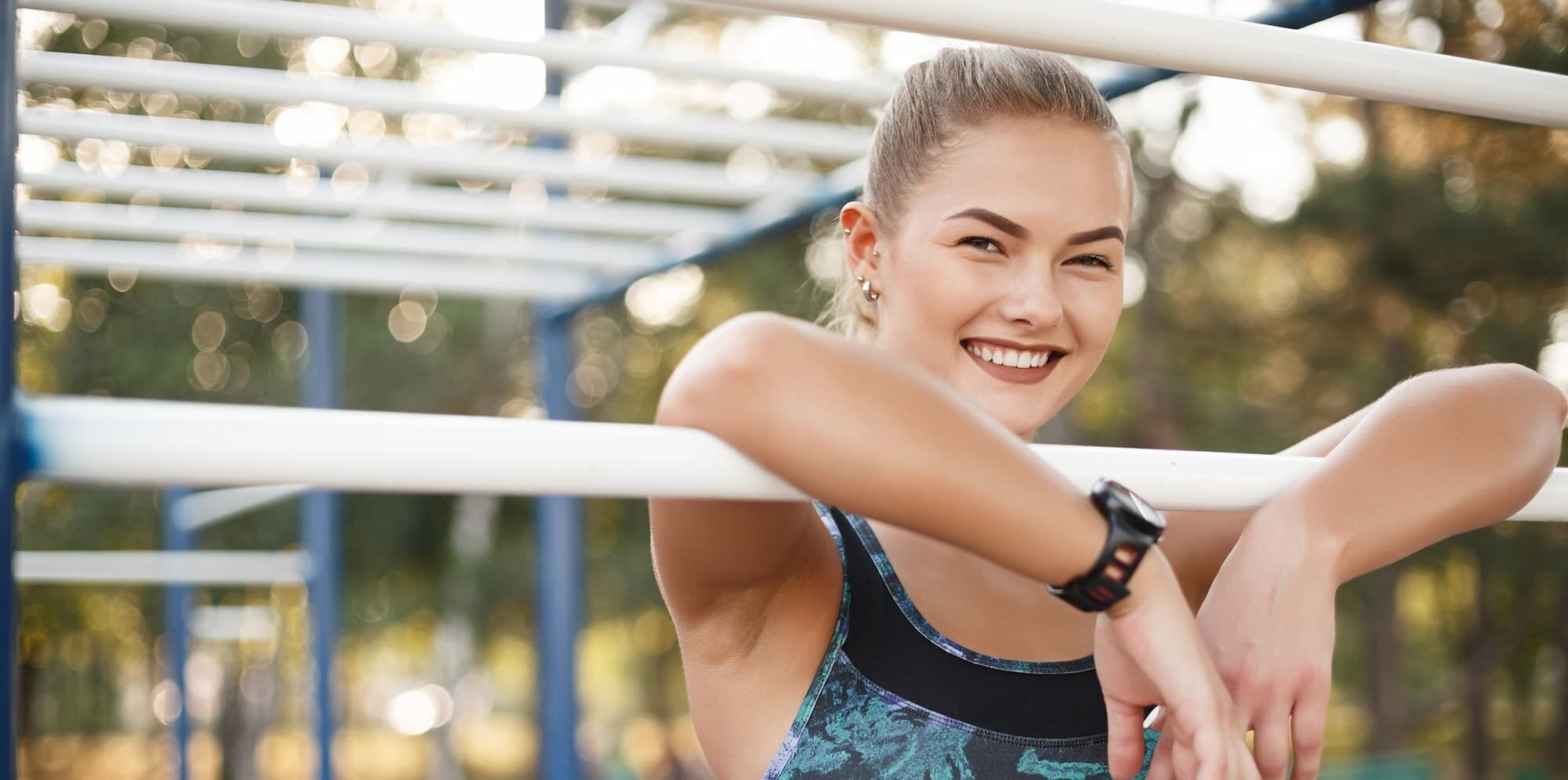 Girl taking a break from workout is happy because she has permanent sweat reduction