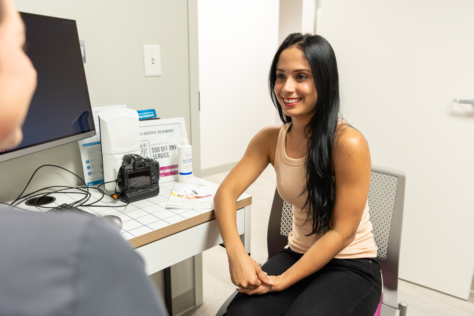 A woman smiles at her laser technician before a treatment in Germantown, TN