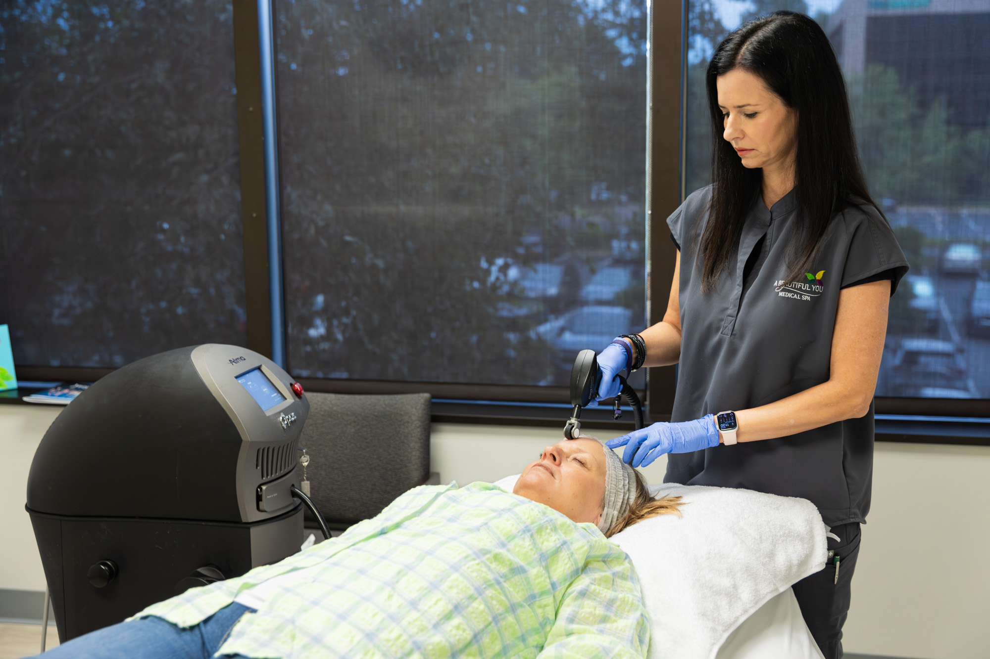 A woman administering acne treatment in Germantown, TN